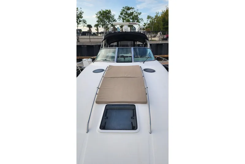 Irish Rover Yacht Photos Pics 2006 Sea Ray 360 Sundancer yacht with sunpad and hatch, docked near trees.