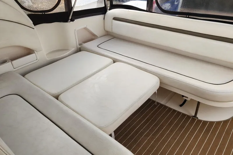 Irish Rover Yacht Photos Pics 2006 Sea Ray 360 Sundancer interior with white leather seating and striped flooring.