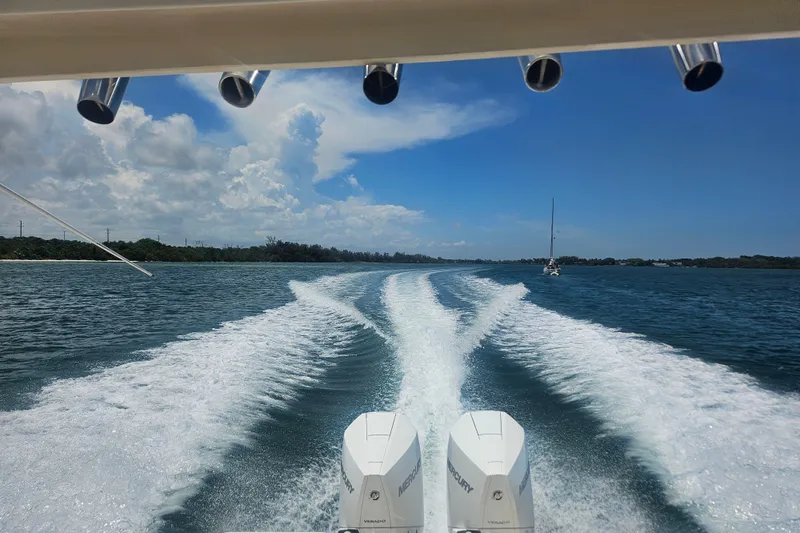  Yacht Photos Pics 2012 Pursuit C 310 Center Console boat cruising on open water, leaving a wake trail.