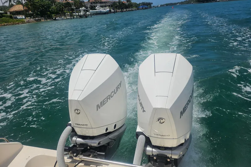  Yacht Photos Pics Twin Mercury Verado engines on a 2012 Pursuit C 310 Center Console boat in clear waters.