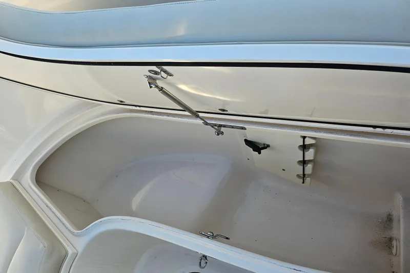  Yacht Photos Pics 2012 Pursuit C 310 Center Console storage compartment with open hatch and clean interior.