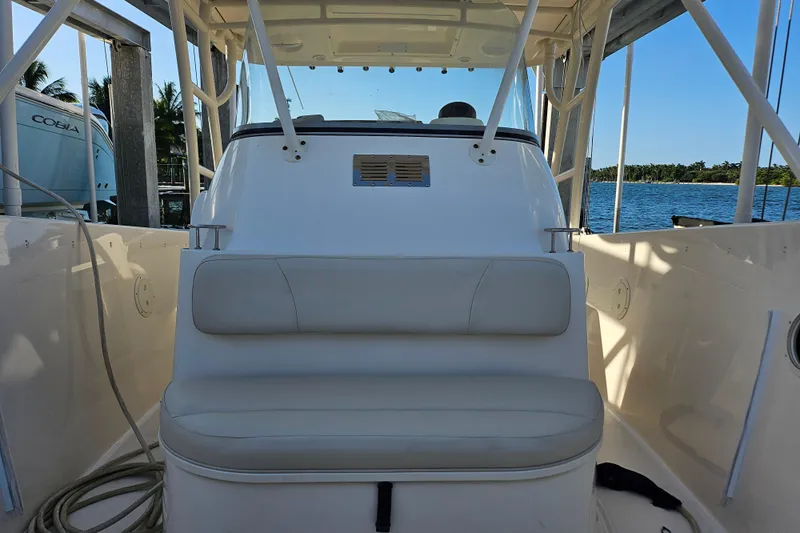  Yacht Photos Pics 2012 Pursuit C 310 Center Console boat interior with seating, docked by the water.