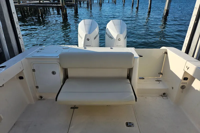  Yacht Photos Pics 2012 Pursuit C 310 Center Console boat with twin Mercury engines, docked by the water.