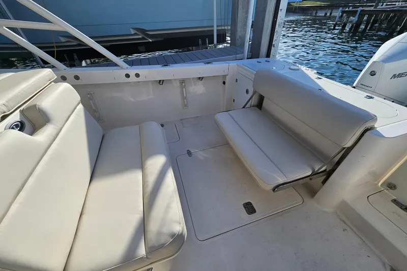  Yacht Photos Pics 2012 Pursuit C 310 Center Console boat interior with cushioned seating and water view.