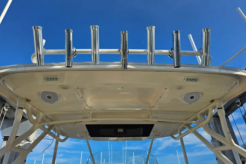  Yacht Photos Pics 2012 Pursuit C 310 Center Console boat with rod holders and speakers under clear blue sky.