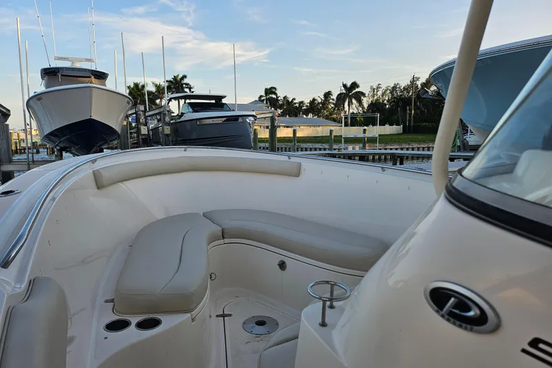  Yacht Photos Pics 2012 Pursuit C 310 Center Console boat docked with cushioned seating area.