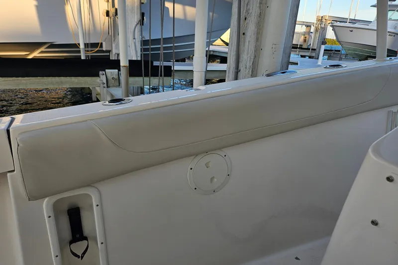  Yacht Photos Pics 2012 Pursuit C 310 Center Console boat interior with cushioned seating and cup holders.