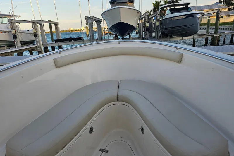  Yacht Photos Pics 2012 Pursuit C 310 Center Console boat interior with cushioned seating at dock.