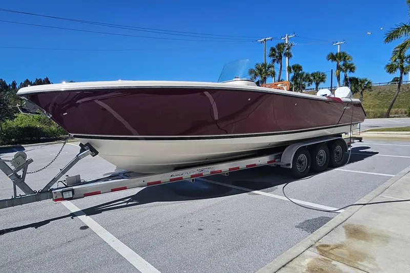  Yacht Photos Pics 2012 Pursuit C 310 Center Console boat on trailer in sunny parking lot.