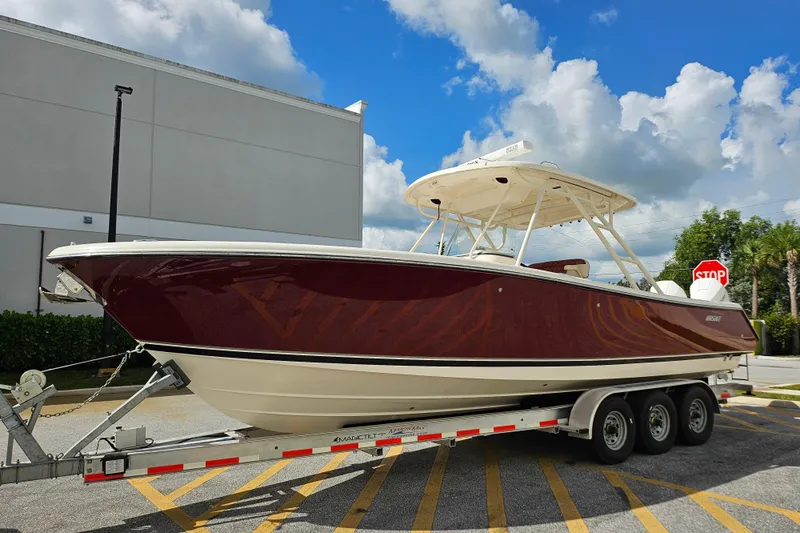  Yacht Photos Pics 2012 Pursuit C 310 Center Console boat on trailer, parked outdoors.