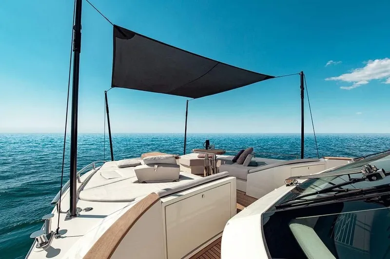 Illuzion Yacht Photos Pics Luxurious 2020 Monte Carlo Yachts MCY 70 on open sea, featuring elegant deck and sunshade.