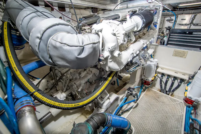 Aquila II Yacht Photos Pics Engine room of a 1990 Bertram 50 Convertible yacht, showcasing detailed machinery.