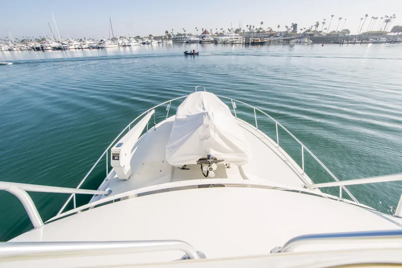 Aquila II Yacht Photos Pics Bow view of 1990 Bertram 50 Convertible yacht in a marina setting.