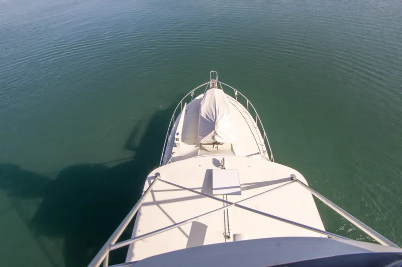 Aquila II Yacht Photos Pics Aerial view of 1990 Bertram 50 Convertible yacht on calm water.