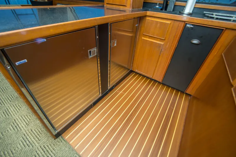 Aquila II Yacht Photos Pics Luxurious wooden interior of 1990 Bertram 50 Convertible yacht kitchen.