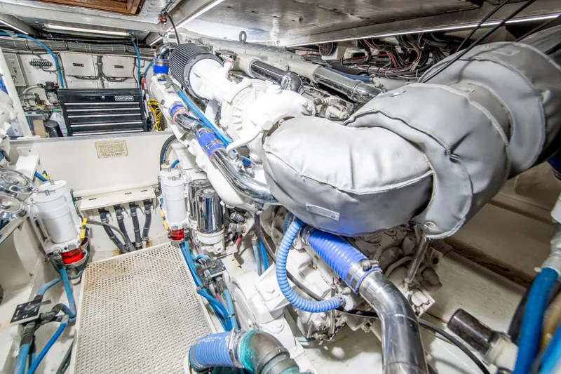 Aquila II Yacht Photos Pics Engine room of a 1990 Bertram 50 Convertible yacht, showcasing detailed machinery and components.