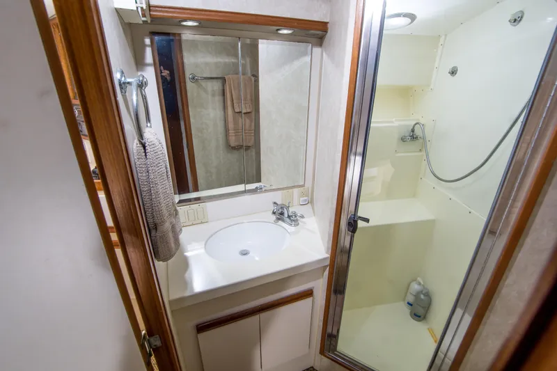 Aquila II Yacht Photos Pics Bathroom interior of 1990 Bertram 50 Convertible yacht, featuring sink and shower.