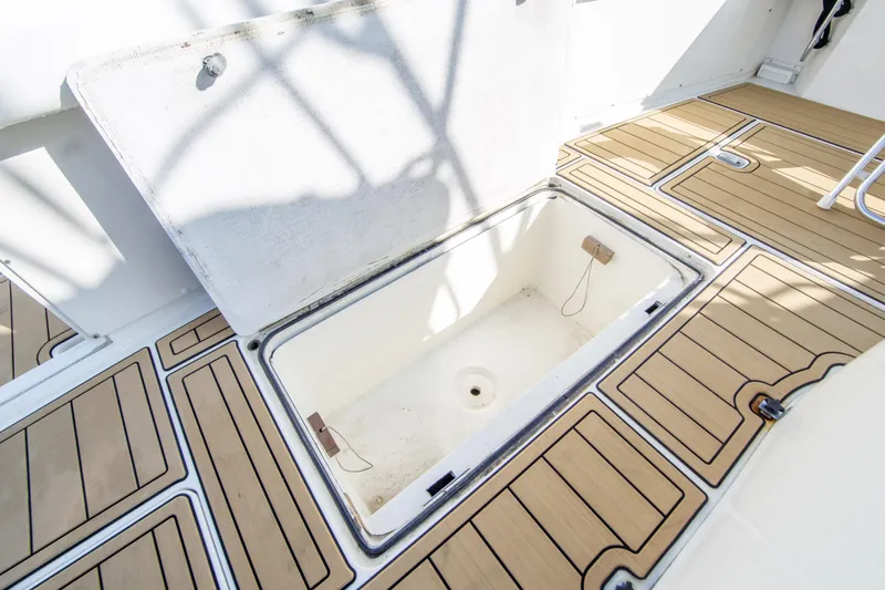 Aquila II Yacht Photos Pics Open storage compartment on 1990 Bertram 50 Convertible boat with teak flooring.