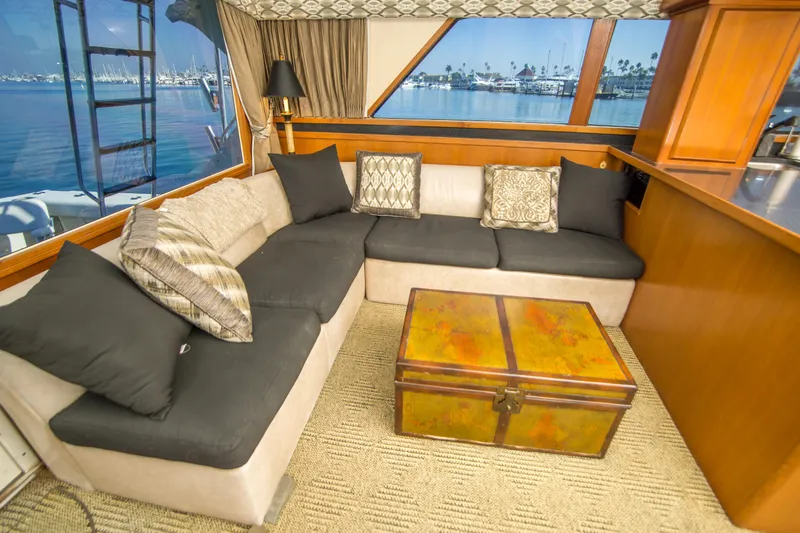 Aquila II Yacht Photos Pics Luxurious interior of a 1990 Bertram 50 Convertible yacht with plush seating and scenic views.