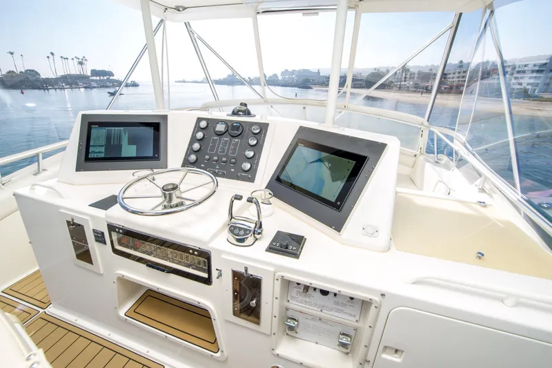 Aquila II Yacht Photos Pics Cockpit of 1990 Bertram 50 Convertible yacht with modern navigation equipment.