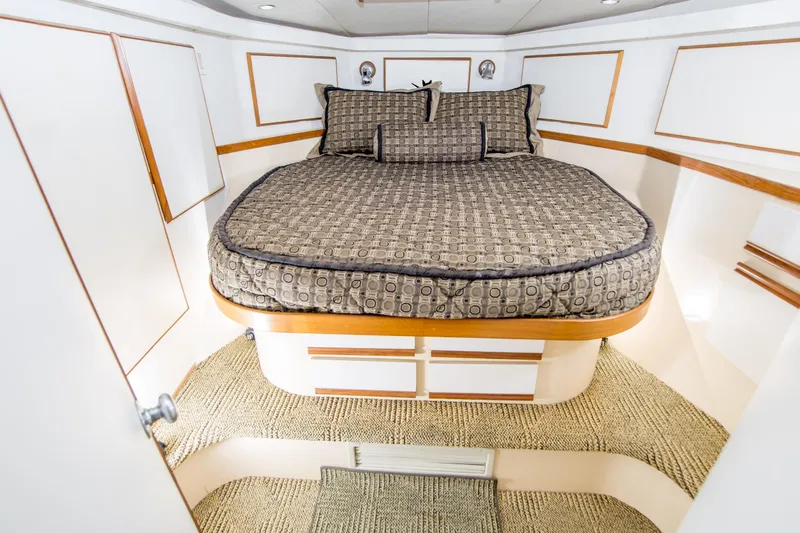 Aquila II Yacht Photos Pics Interior cabin of a 1990 Bertram 50 Convertible yacht with a cozy bed.