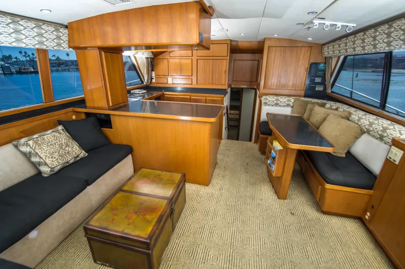 Aquila II Yacht Photos Pics Luxurious interior of a 1990 Bertram 50 Convertible yacht with elegant wood finishes.