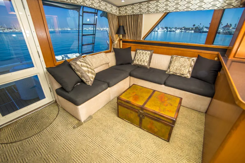 Aquila II Yacht Photos Pics Luxurious interior of a 1990 Bertram 50 Convertible yacht with plush seating and ocean view.