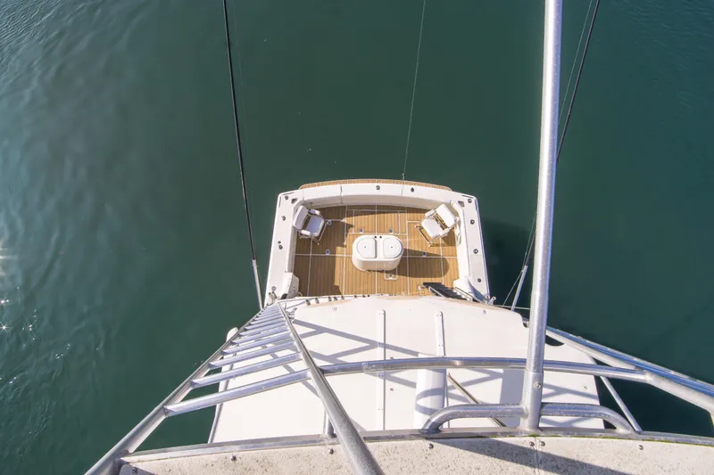 Aquila II Yacht Photos Pics Aerial view of 1990 Bertram 50 Convertible yacht deck over calm water.