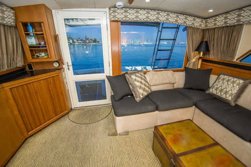 Aquila II Yacht Photos Pics Interior of 1990 Bertram 50 Convertible yacht with cozy seating and ocean view.