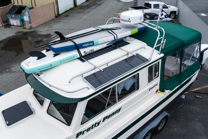 Pretty Penny Yacht Photos Pics 2006 C-Dory 25' Tomcat Catamaran with paddleboards on roof, docked in marina.