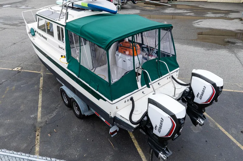 Pretty Penny Yacht Photos Pics 2006 C-Dory 25' Tomcat Catamaran with green canopy and twin Evinrude engines.