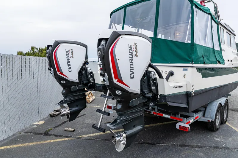 Pretty Penny Yacht Photos Pics 2006 C-Dory 25' Tomcat Catamaran with dual Evinrude engines on a trailer.