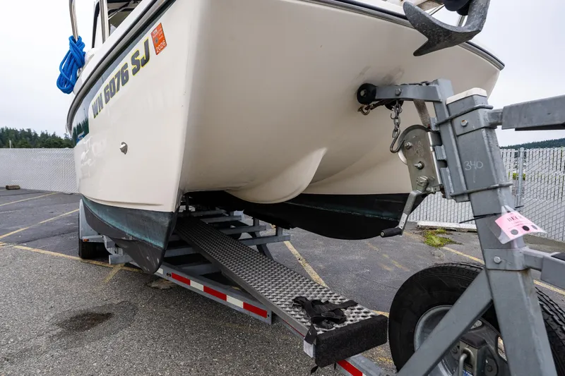 Pretty Penny Yacht Photos Pics 2006 C-Dory 25' Tomcat Catamaran on trailer, parked in a lot.