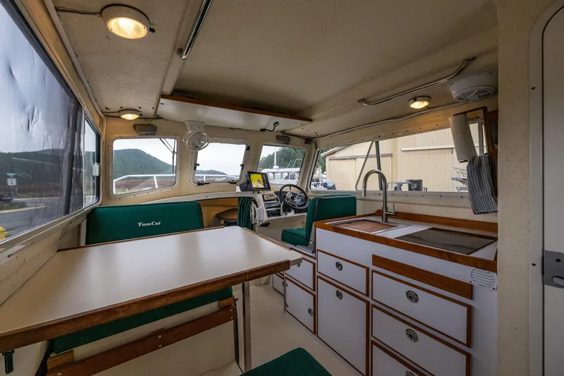 Pretty Penny Yacht Photos Pics Interior of 2006 C-Dory 25' Tomcat Catamaran with dining area and kitchenette.