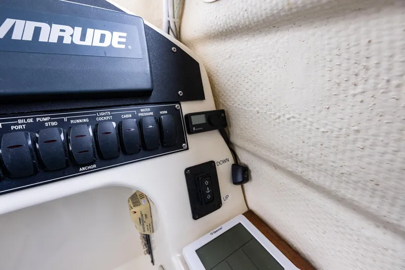 Pretty Penny Yacht Photos Pics Control panel of a 2006 C-Dory 25' Tomcat Catamaran with switches and Evinrude branding.