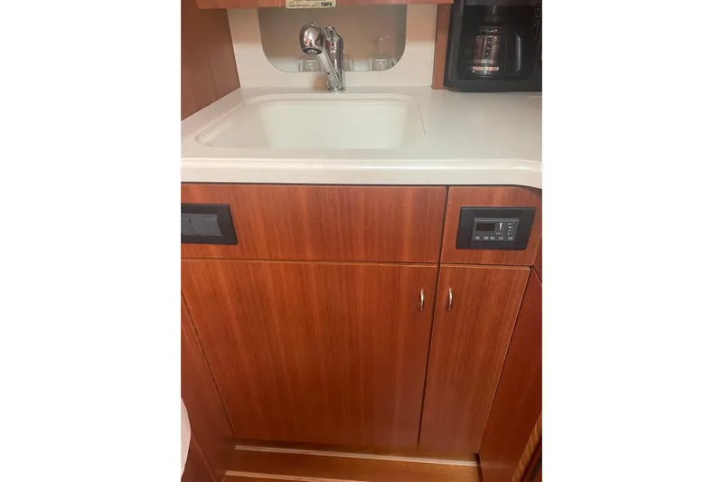 Son Days Yacht Photos Pics 2006 Tiara Yachts 3800 Open galley with sink, wooden cabinetry, and coffee maker.