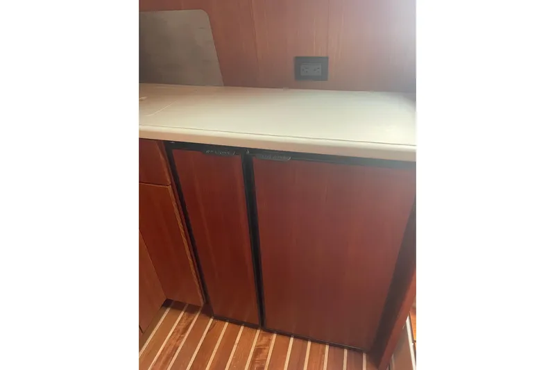 Son Days Yacht Photos Pics 2006 Tiara Yachts 3800 Open interior with wooden cabinetry and dual refrigerators.