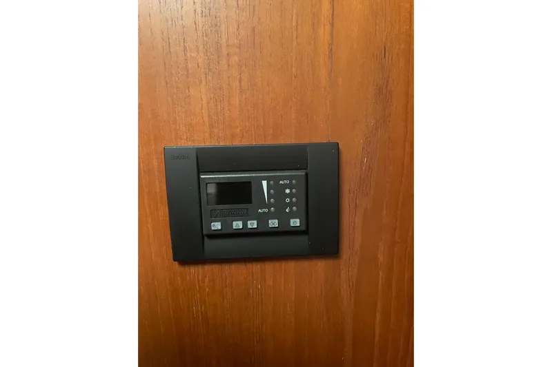 Son Days Yacht Photos Pics Control panel on 2006 Tiara Yachts 3800 Open, mounted on wooden surface.