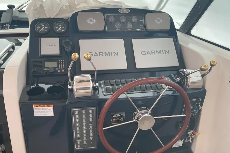 Son Days Yacht Photos Pics 2006 Tiara Yachts 3800 Open helm with Garmin navigation and classic wooden steering wheel.