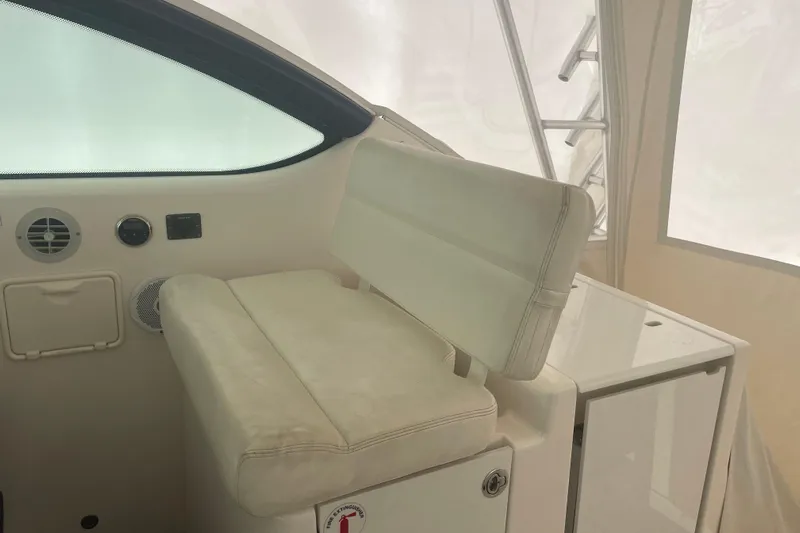 Son Days Yacht Photos Pics Interior seating of 2006 Tiara Yachts 3800 Open, featuring white upholstery and control panel.