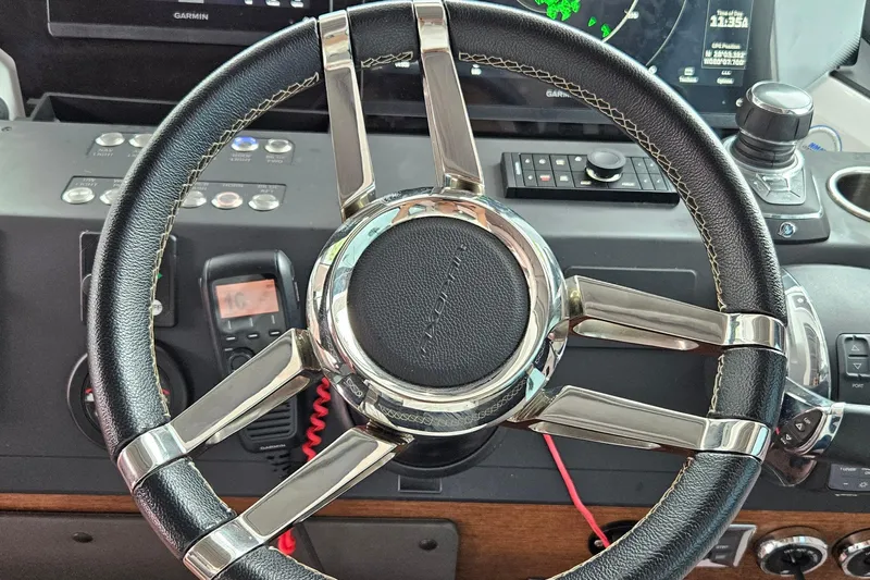 Wanderlust Yacht Photos Pics Steering wheel of 2020 Axopar 37 XC Cross Cabin with navigation controls.