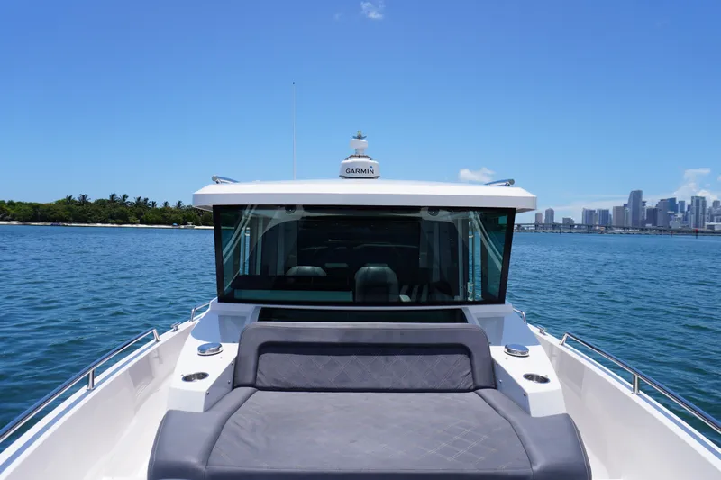 Wanderlust Yacht Photos Pics 2020 Axopar 37 XC Cross Cabin on water with city skyline in background.