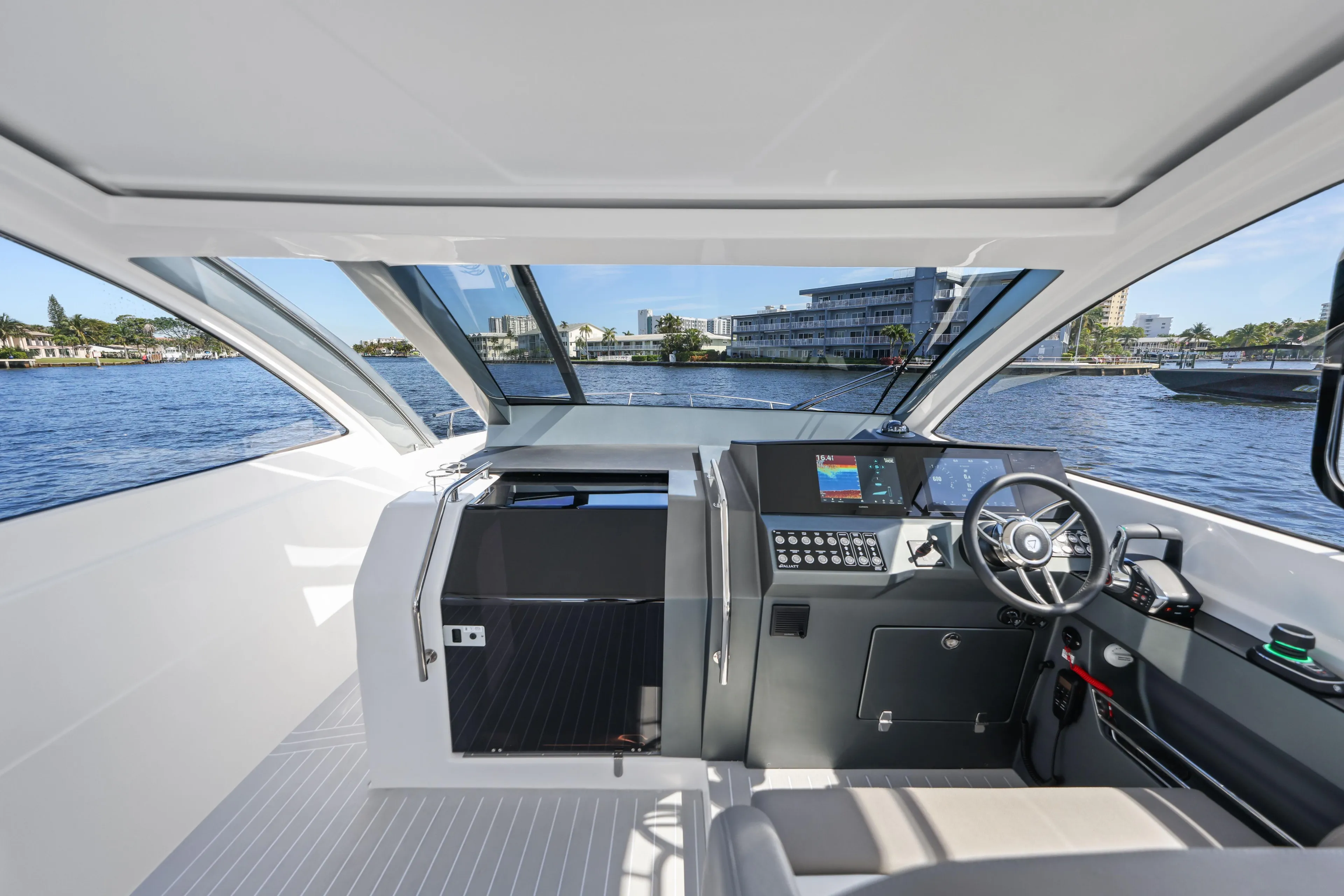 Interior view of 2025 VALIATT YACHTS 380 Bowrider, featuring modern helm and waterfront backdrop.