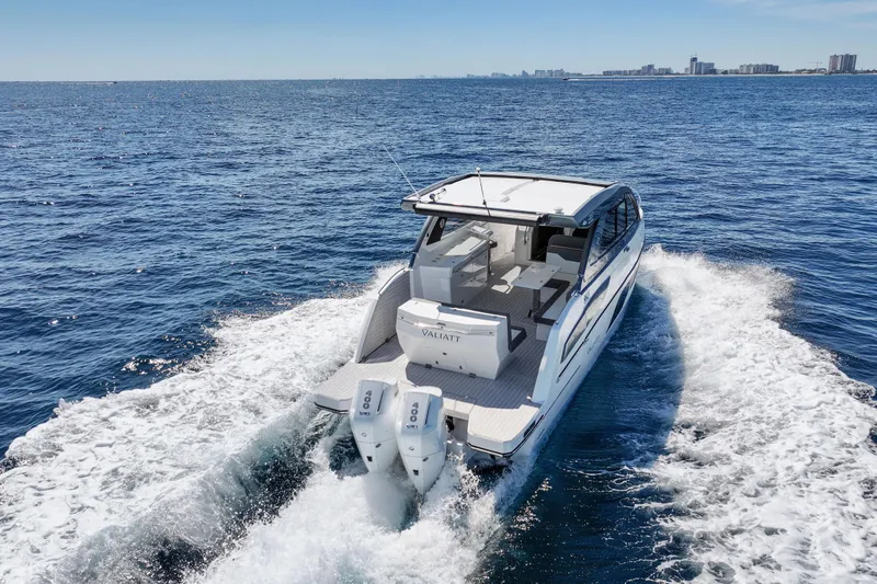  Yacht Photos Pics 2025 VALIATT YACHTS 380 Bowrider cruising on open sea with city skyline in background.
