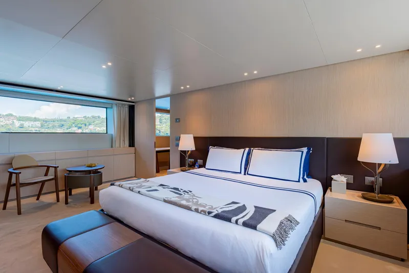  Yacht Photos Pics Luxurious bedroom interior on 2024 Sanlorenzo SD118 yacht, featuring modern design and scenic window view.