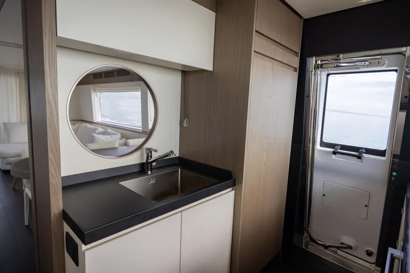 Seahawk Yacht Photos Pics Interior of 2025 Azimut Magellano 66 yacht, featuring modern sink and porthole window.