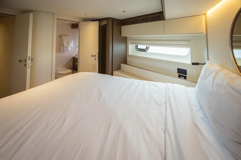Seahawk Yacht Photos Pics Luxurious bedroom interior of 2025 Azimut Magellano 66 yacht with ensuite bathroom.