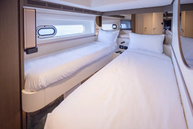 Seahawk Yacht Photos Pics Luxurious twin cabin interior of 2025 Azimut Magellano 66 yacht, featuring modern design and comfort.