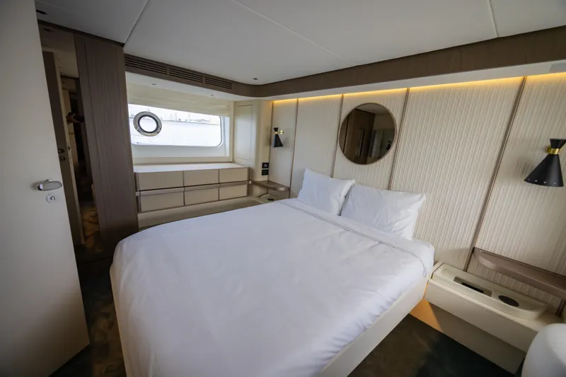 Seahawk Yacht Photos Pics Luxurious bedroom interior of 2025 Azimut Magellano 66 yacht, featuring modern design and elegant furnishings.
