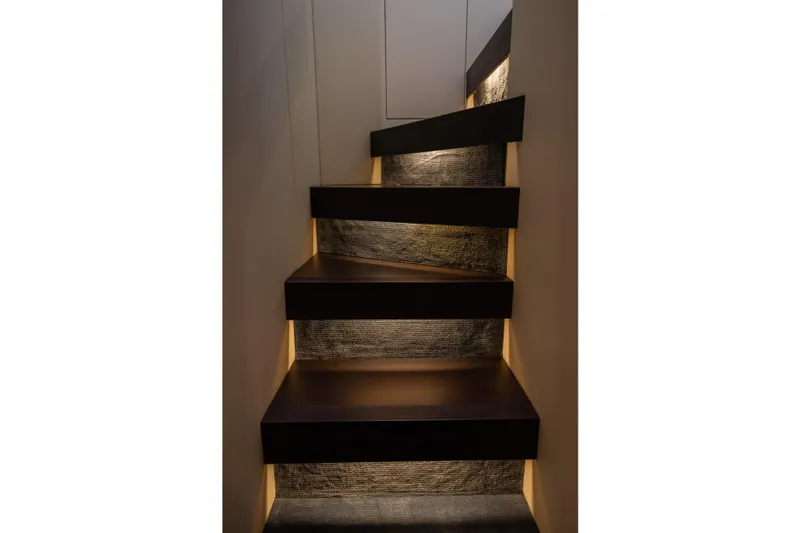 Seahawk Yacht Photos Pics Illuminated staircase on 2025 Azimut Magellano 66 yacht, featuring modern design and ambient lighting.